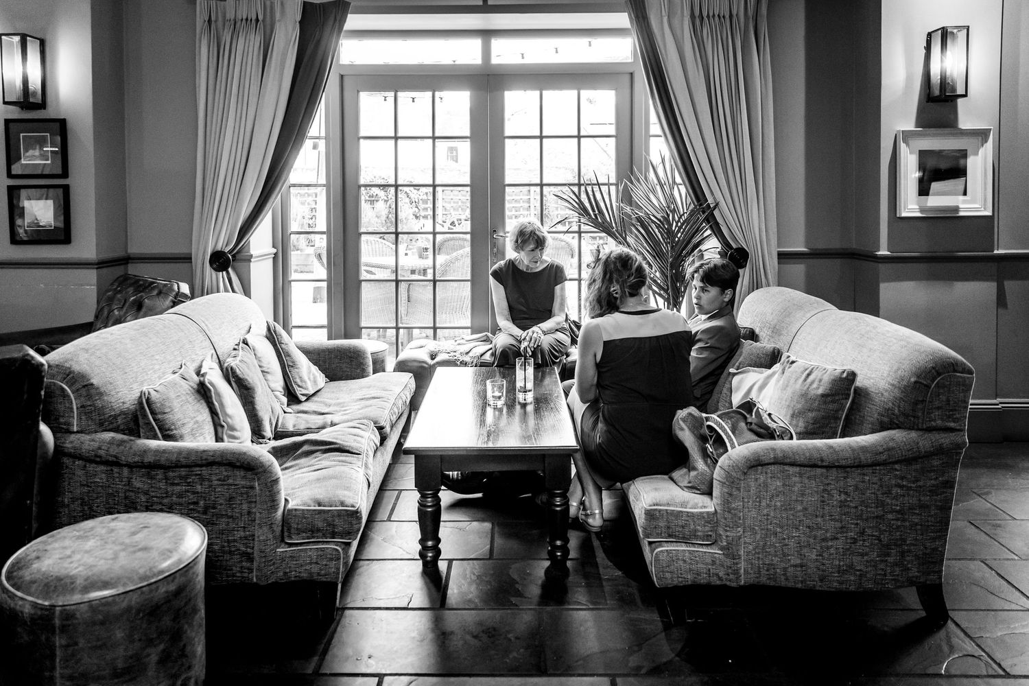 Sunlit living room interior with elegant curtains and comfortable seating arrangements.