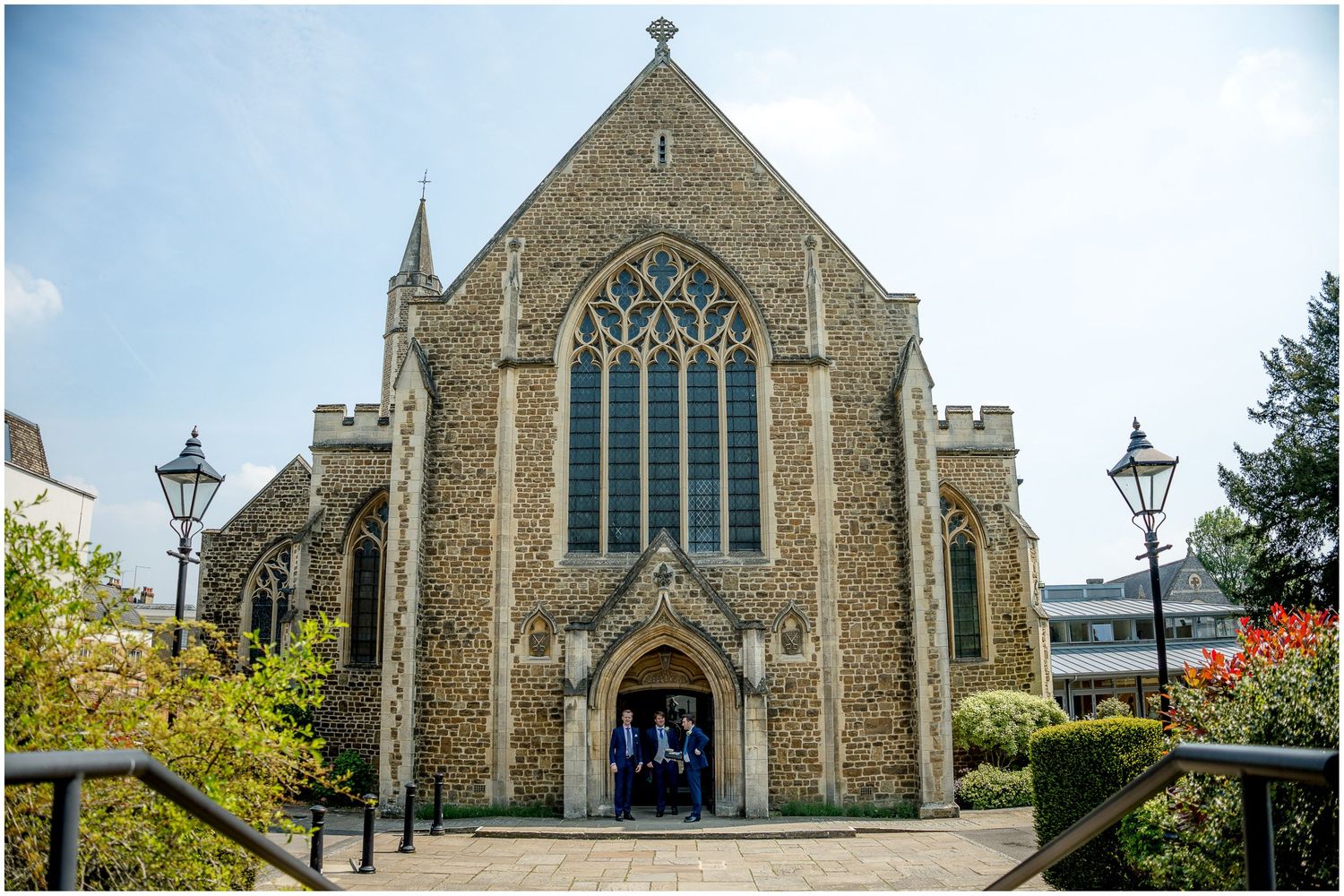 Stone church exterior with Gothic architecture and stained glass windows.