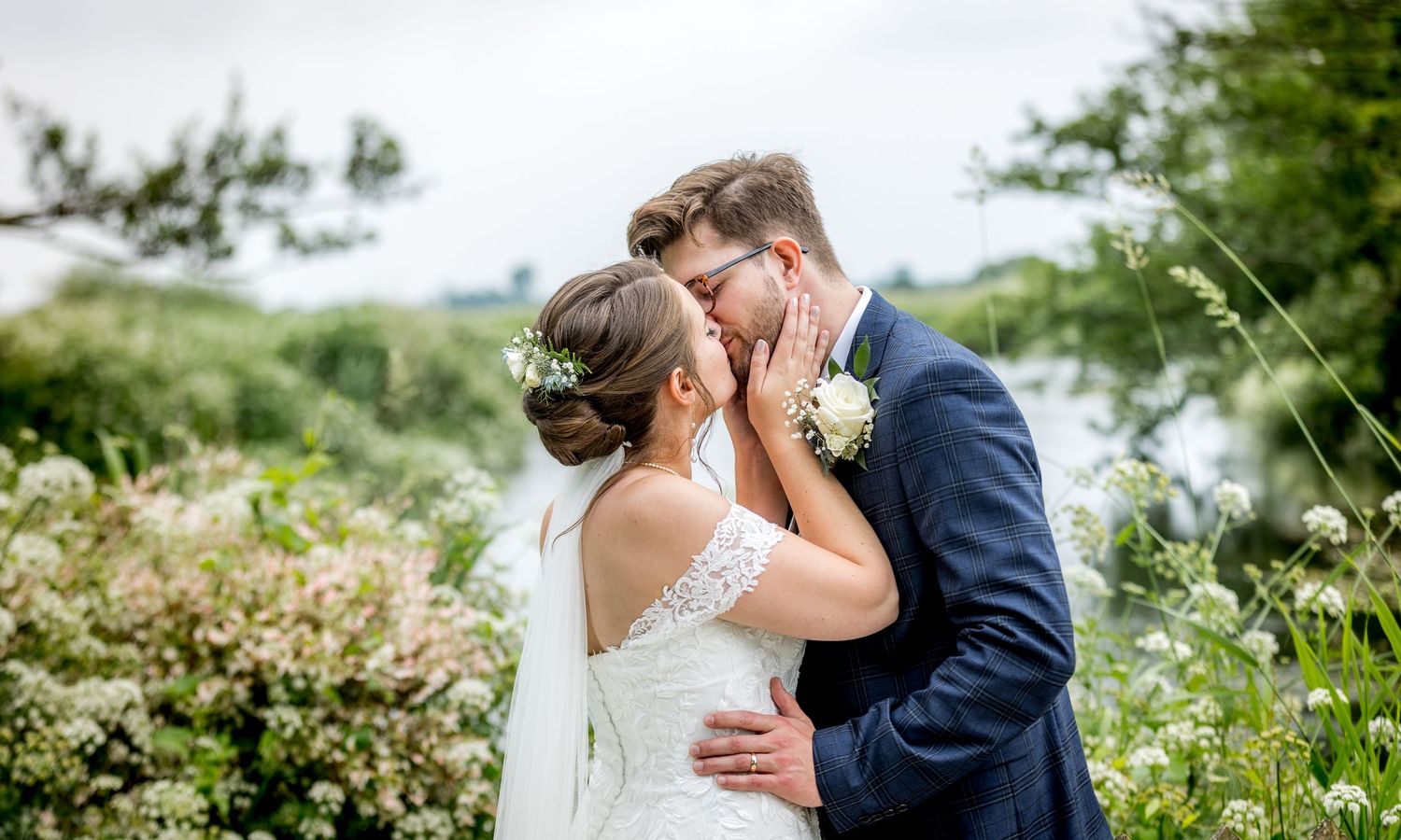 Wedding couple sharing intimate moments in a blooming spring garden.
