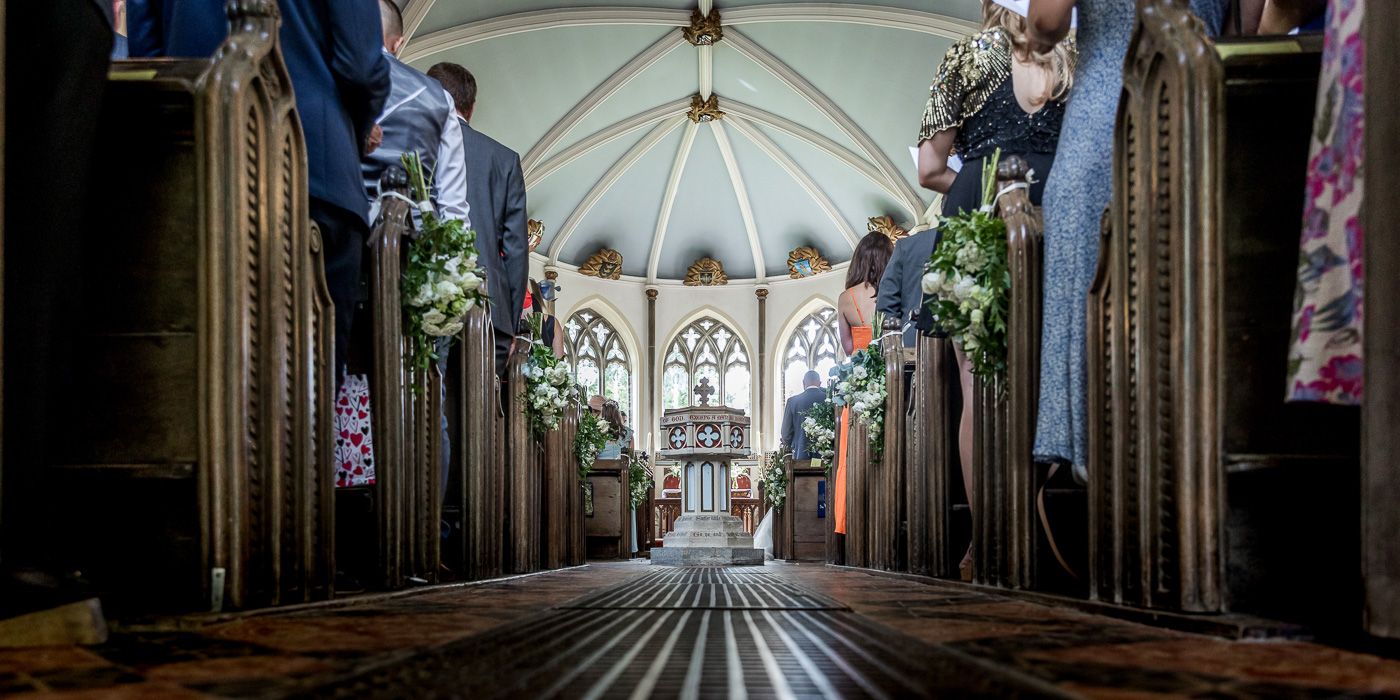 Interior architectural shots of a cathedral with vaulted ceilings and dramatic lighting.