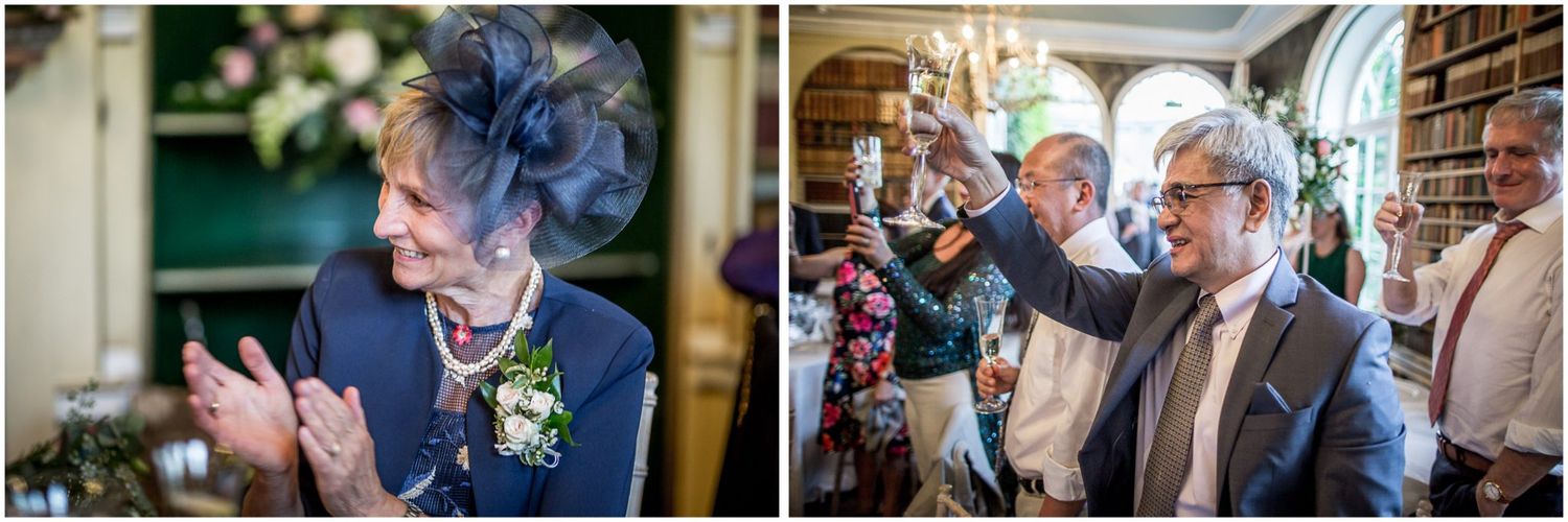 Wedding celebration candids showing guests mingling in an elegant library setting with floral decor.