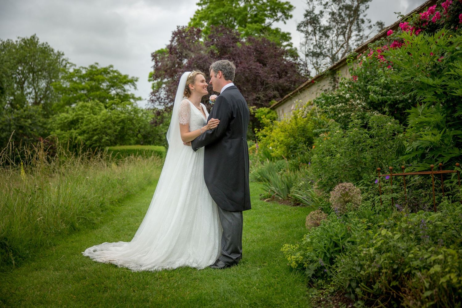 Wedding photography session in the formal gardens of Houghton Lodge, Hampshire wedding venue