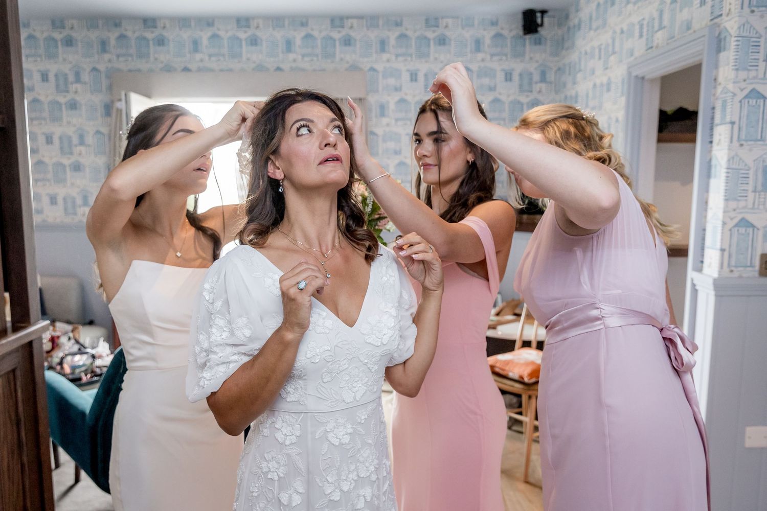 Candid shots of wedding party preparing with natural light streaming through windows.