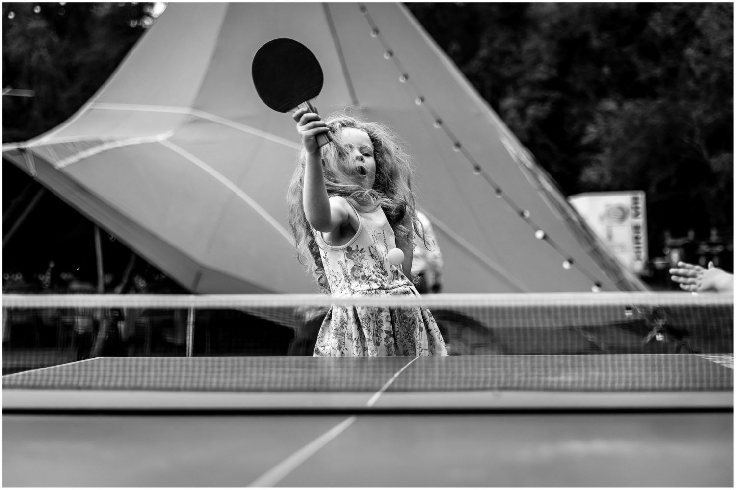 Black and white photographs capturing joyful moments at an outdoor celebration.