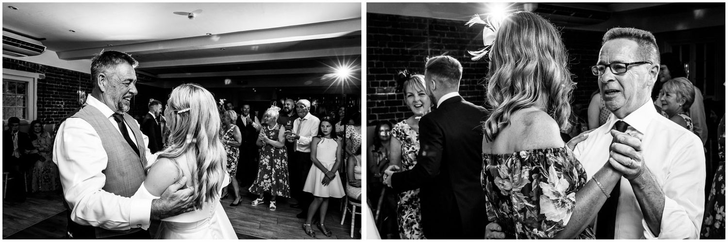 Wedding reception guests dancing and celebrating in a venue with dramatic lighting.