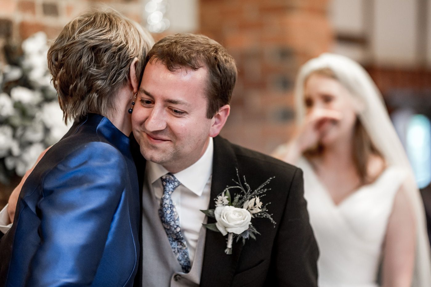 Wedding couple sharing intimate moments during formal photography session.