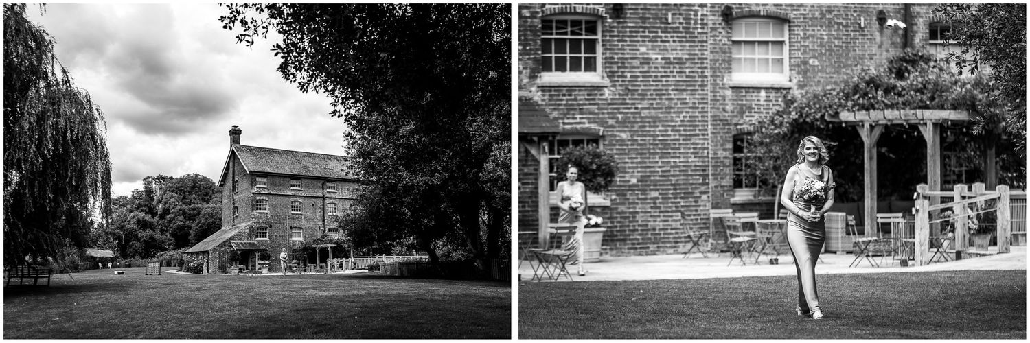 Black and white wedding photography with bridesmaid walking towards Sopley Mill's outdoor ceremony space