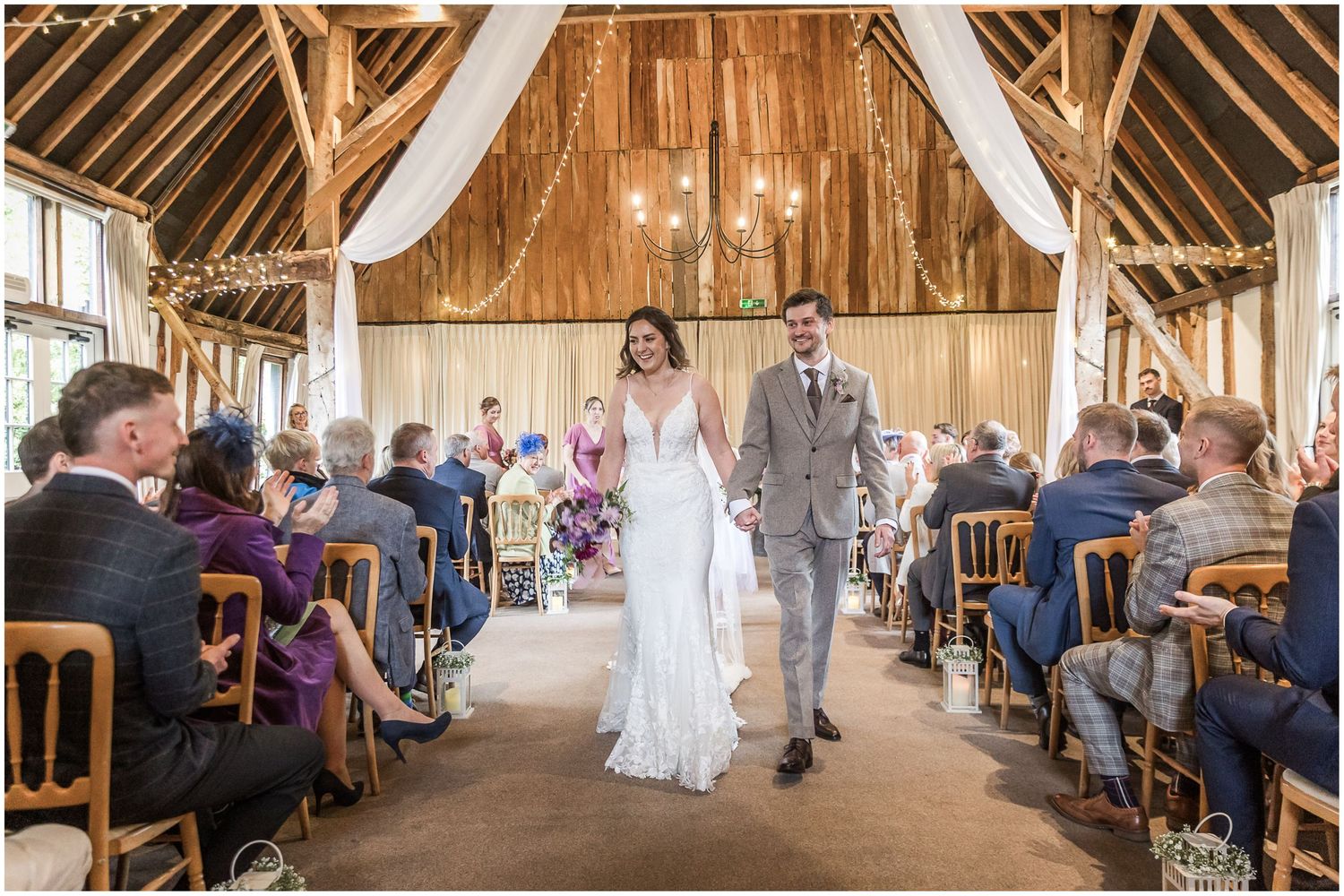 The newly married bride and groom walk back down the aisle as husband and wife
