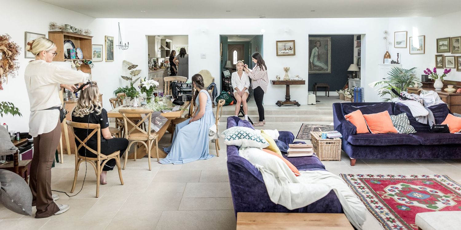 Bright modern living space with white walls, wooden furniture and bohemian decor details.