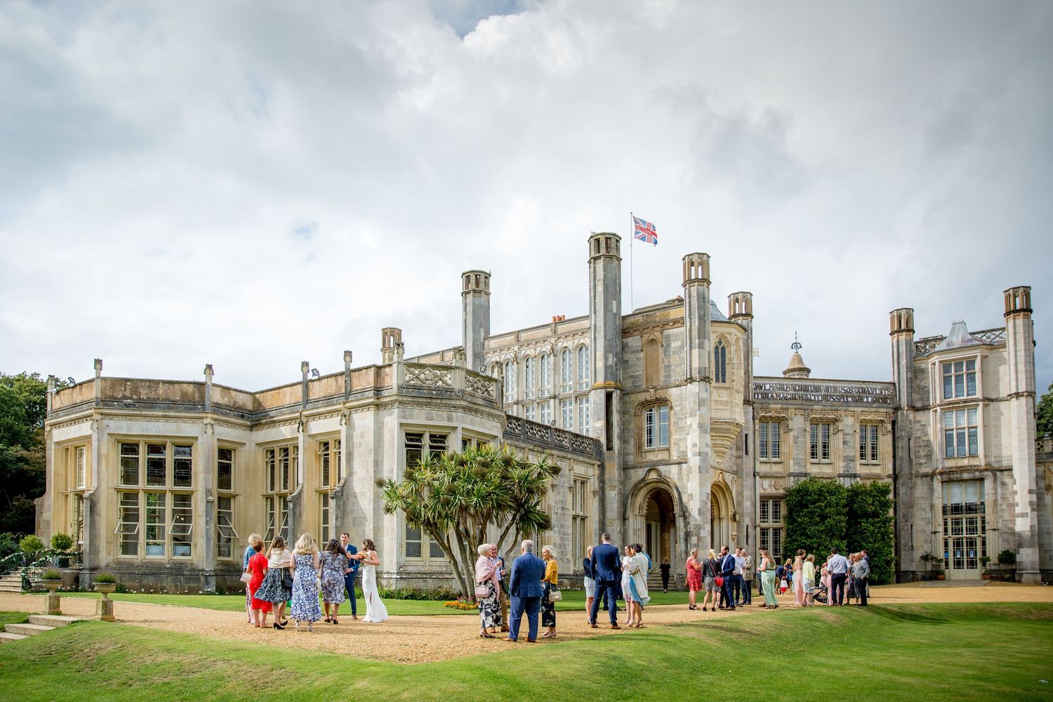 Panoramic view of a grand historic mansion with Gothic architecture and manicured grounds.