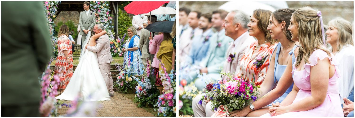 Bridesmaids in colourful dresses watch as the bride arrives for the start of the outdoor wedding ceremony near Winchester.