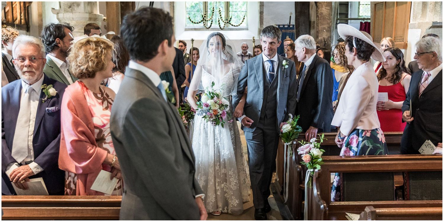 Wedding guests mingling and celebrating during reception in historic venue.