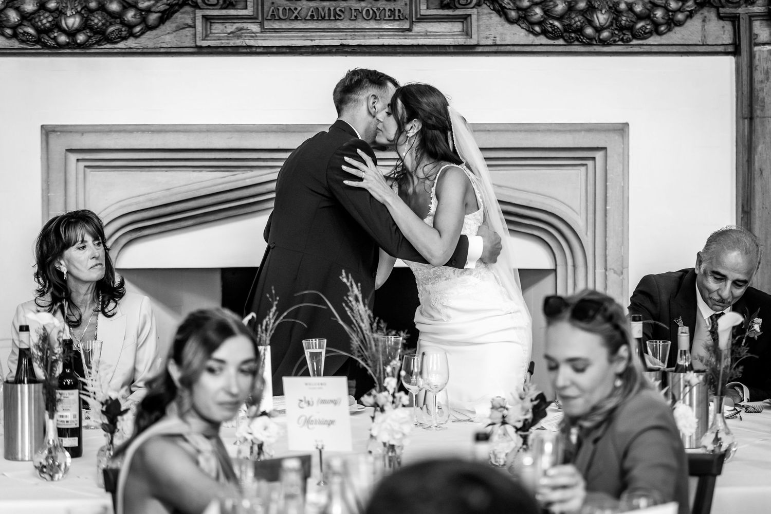 Black and white photo montage showing candid moments during a wedding reception celebration.