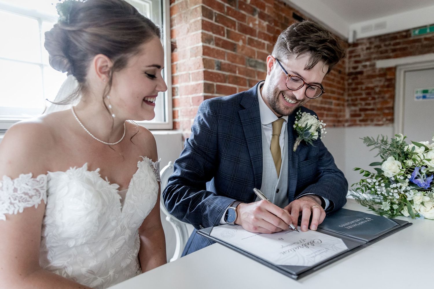 Intimate wedding ceremony moments captured in a light-filled brick venue.