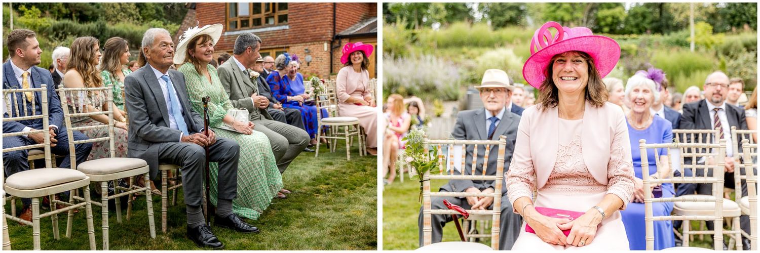 Wedding guests seated outdoors with bright pink and floral decorative accents.