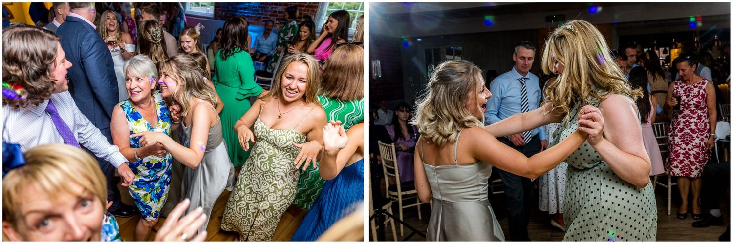 Wedding reception dance floor filled with joyful guests celebrating.