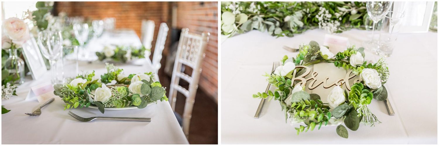 Elegant wedding table settings with white floral centerpieces and greenery against exposed brick walls.