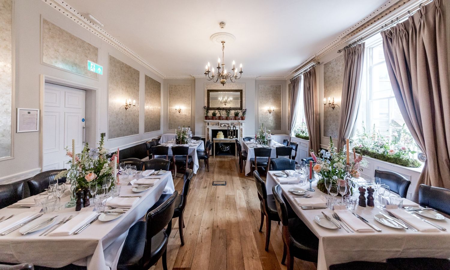 Elegant dining room interior with crystal chandeliers and traditional decor.