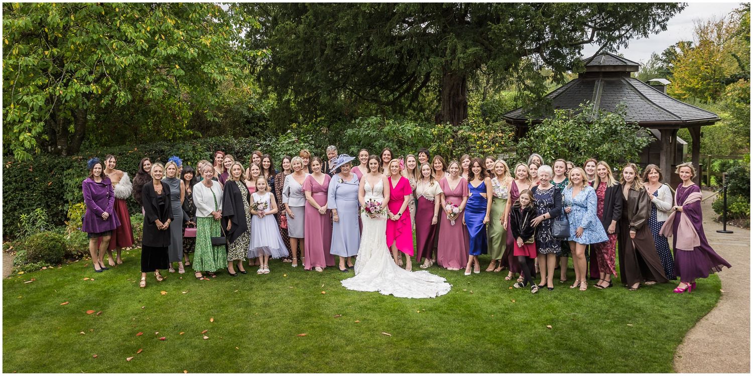 Large group photograph of the full wedding party taken at Clock Barn in Hampshire