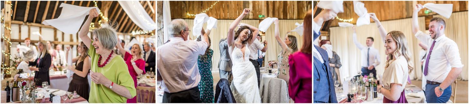 Guests at a Clock Barn wedding greet the couple by waving napkins in the air.