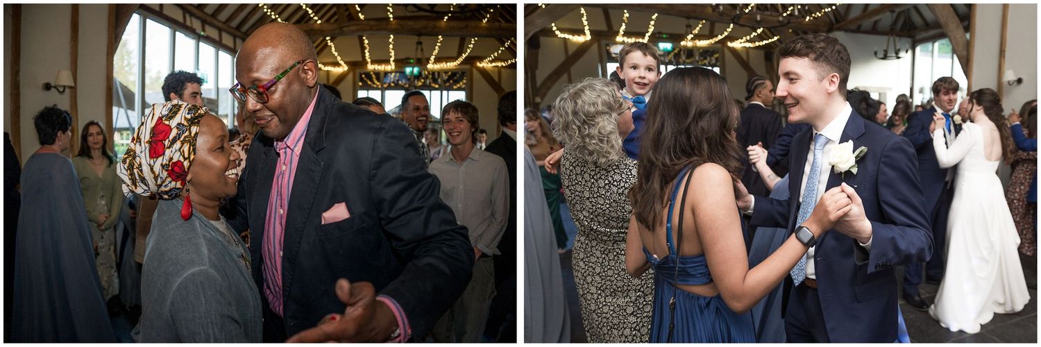 Wedding celebration with guests dancing and mingling under decorative lighting.