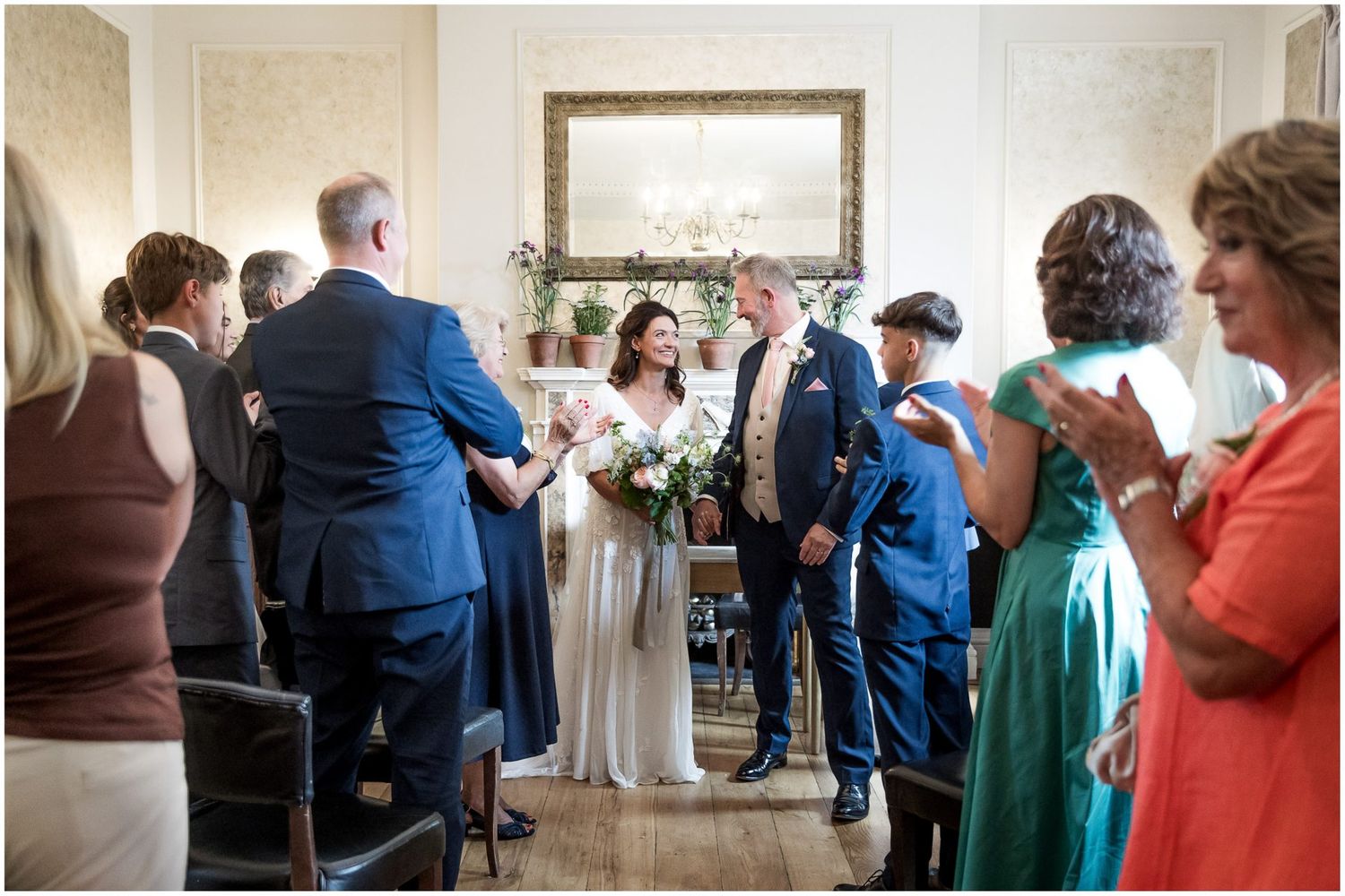 Wedding guests gather in an indoor venue during a celebration event.