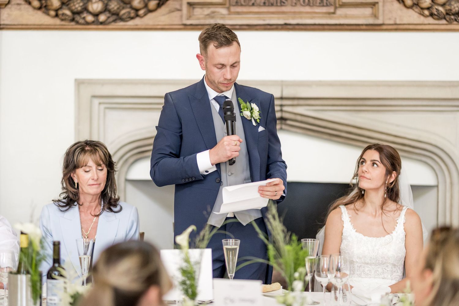 Wedding reception venue with ornate architectural details and elegant table settings.