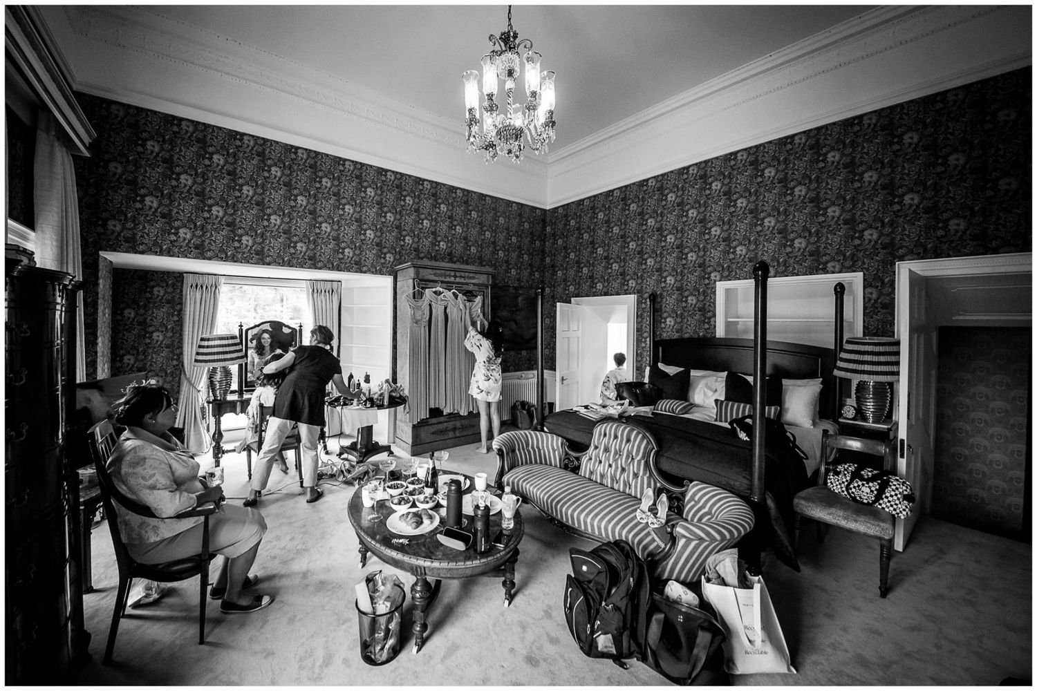 Black and white panorama of elegant interior room with chandelier and vintage decor.