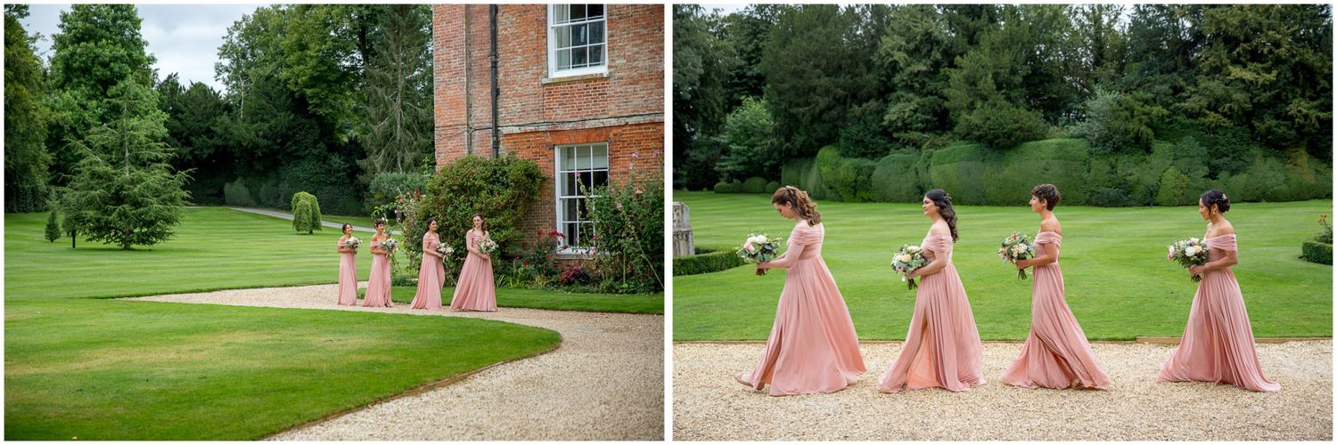 Wedding party walks across manicured lawn at elegant estate venue.