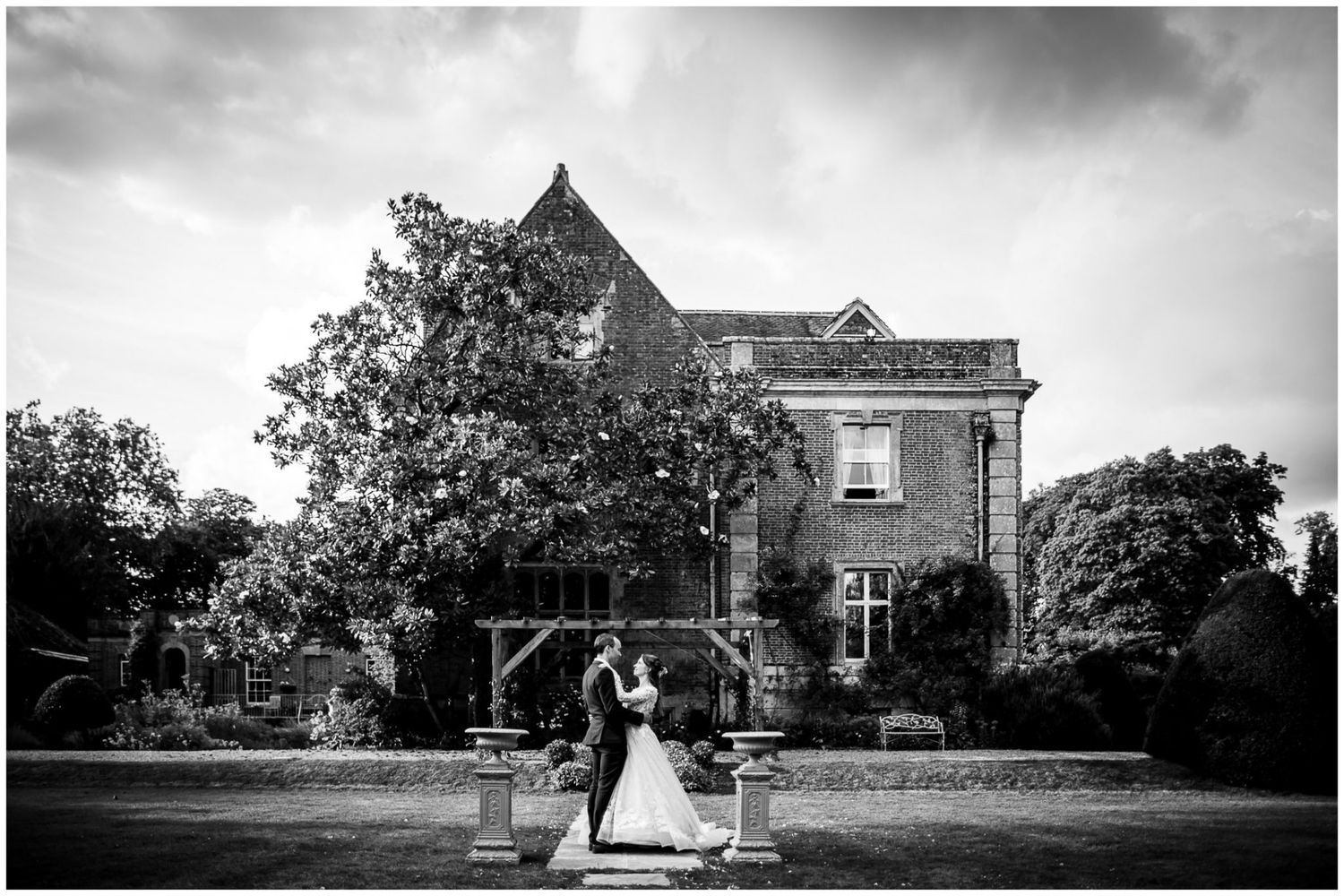 A series of black and white wedding photos showing outdoor ceremony scenes and vintage buildings.