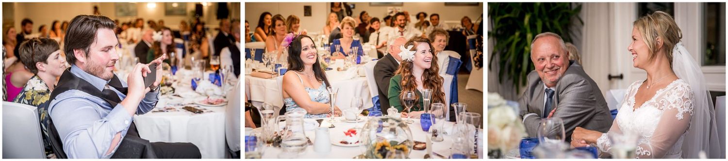 A group of people celebrate at a wedding reception with dining tables and festive decorations.