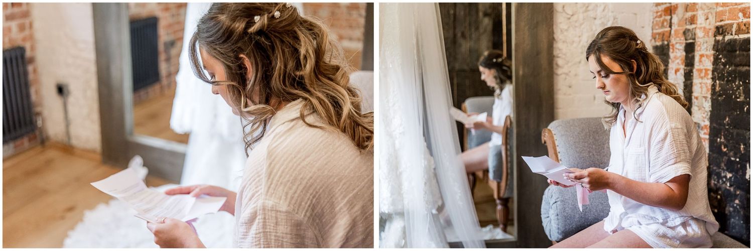 The bride reads a note from the groom on the morning of her wedding day in the bridal preparation rooms at Clock Barn, Hampshire