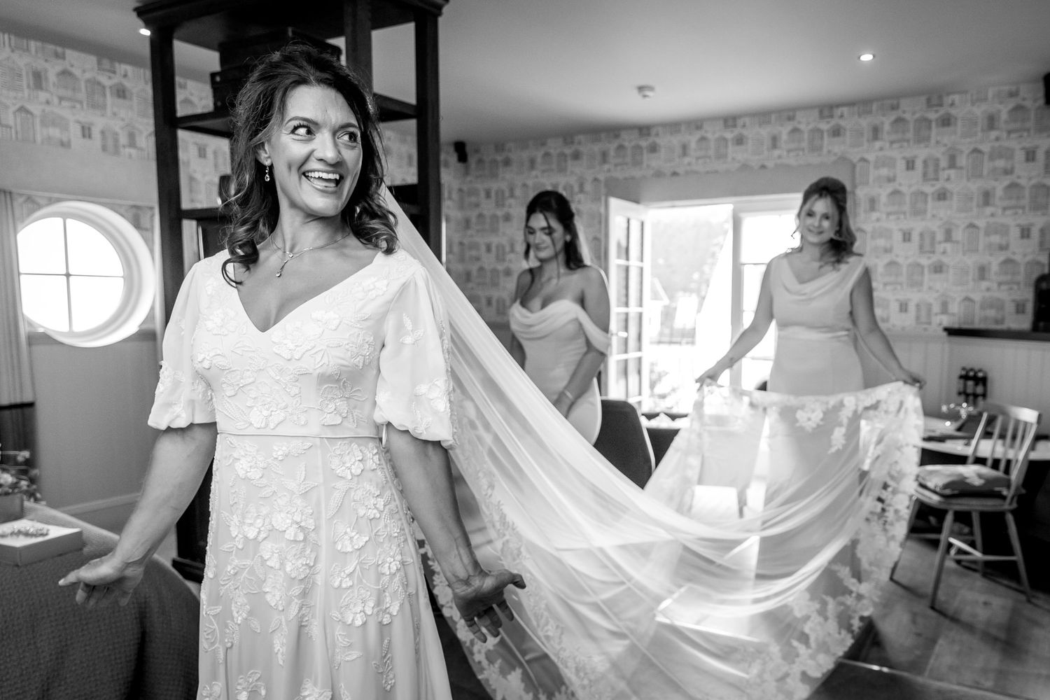 Black and white series showing joyful moments during wedding preparations.