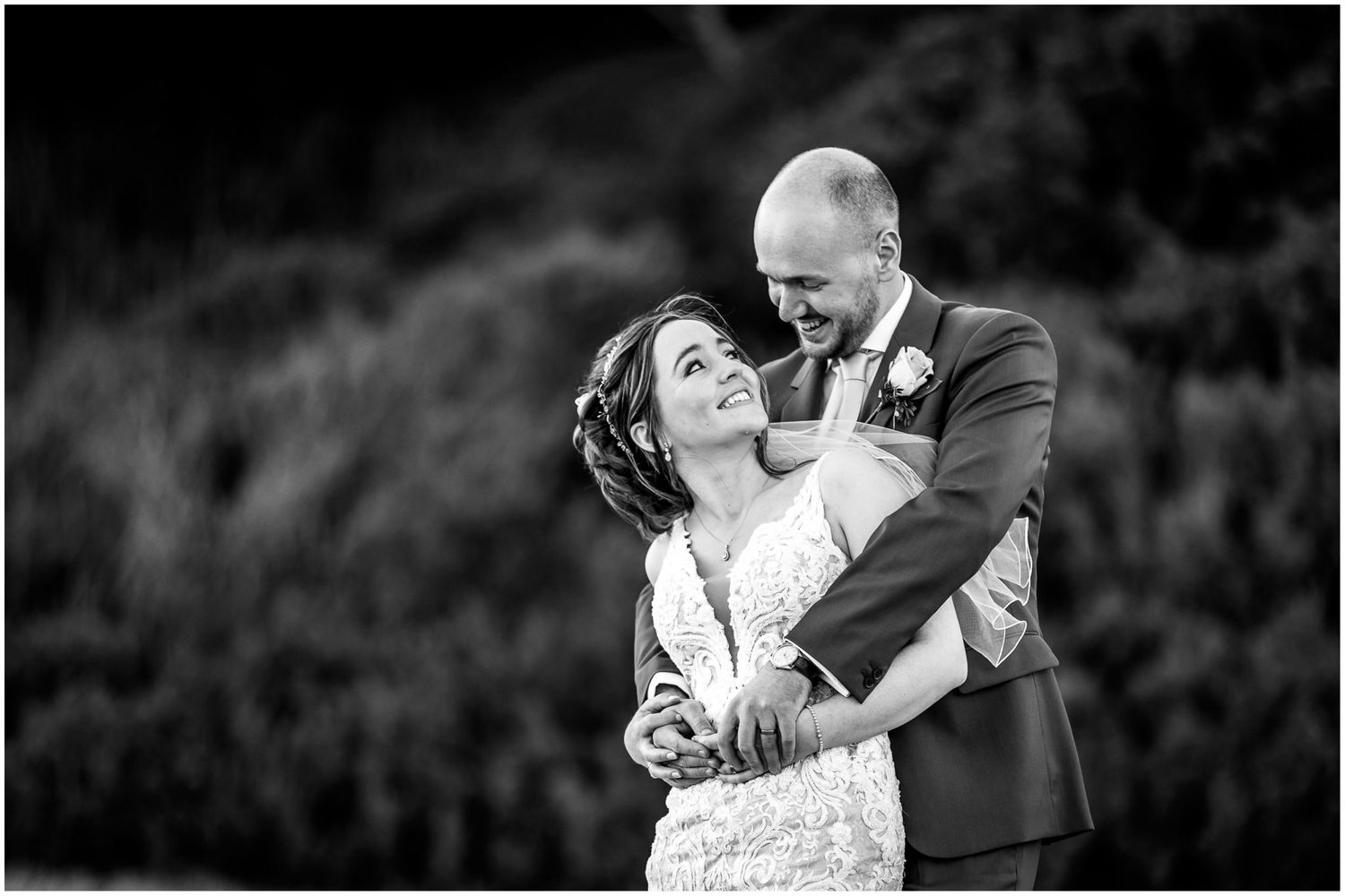 Black and white photo of couple dancing together at their wedding reception.