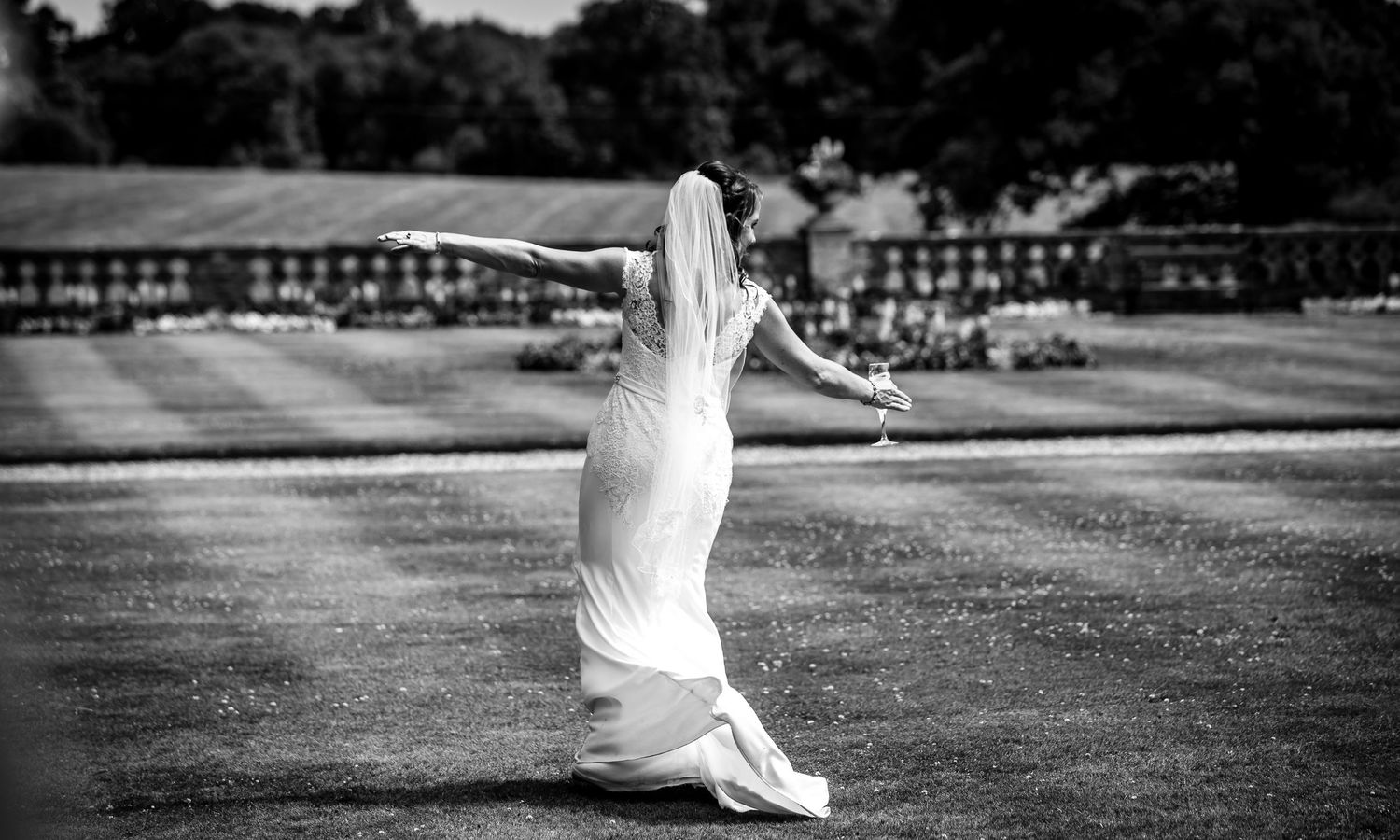 Black and white sequence of a flowing white dress in motion across a courtyard.