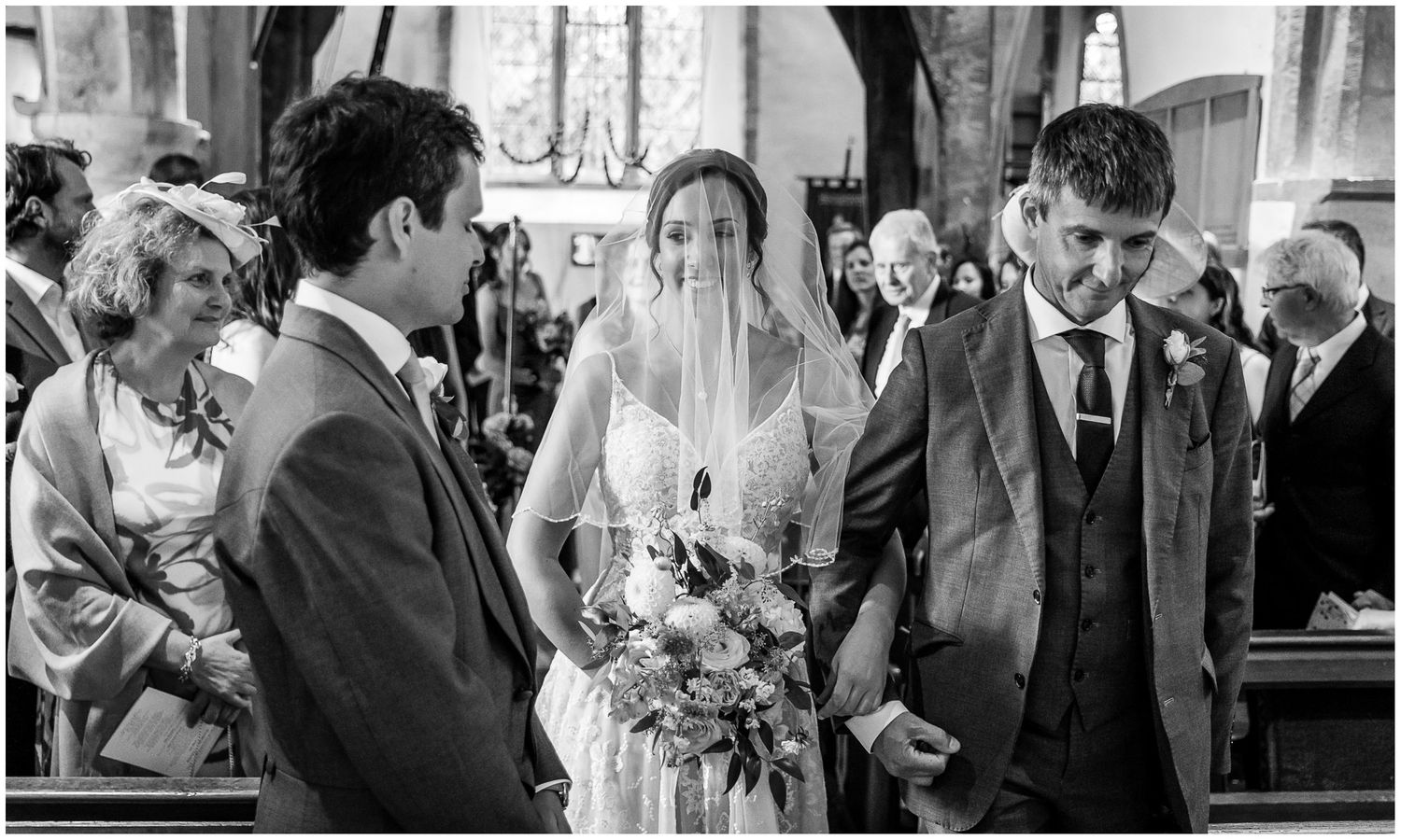 Black and white photos of wedding ceremony moments in traditional church setting.