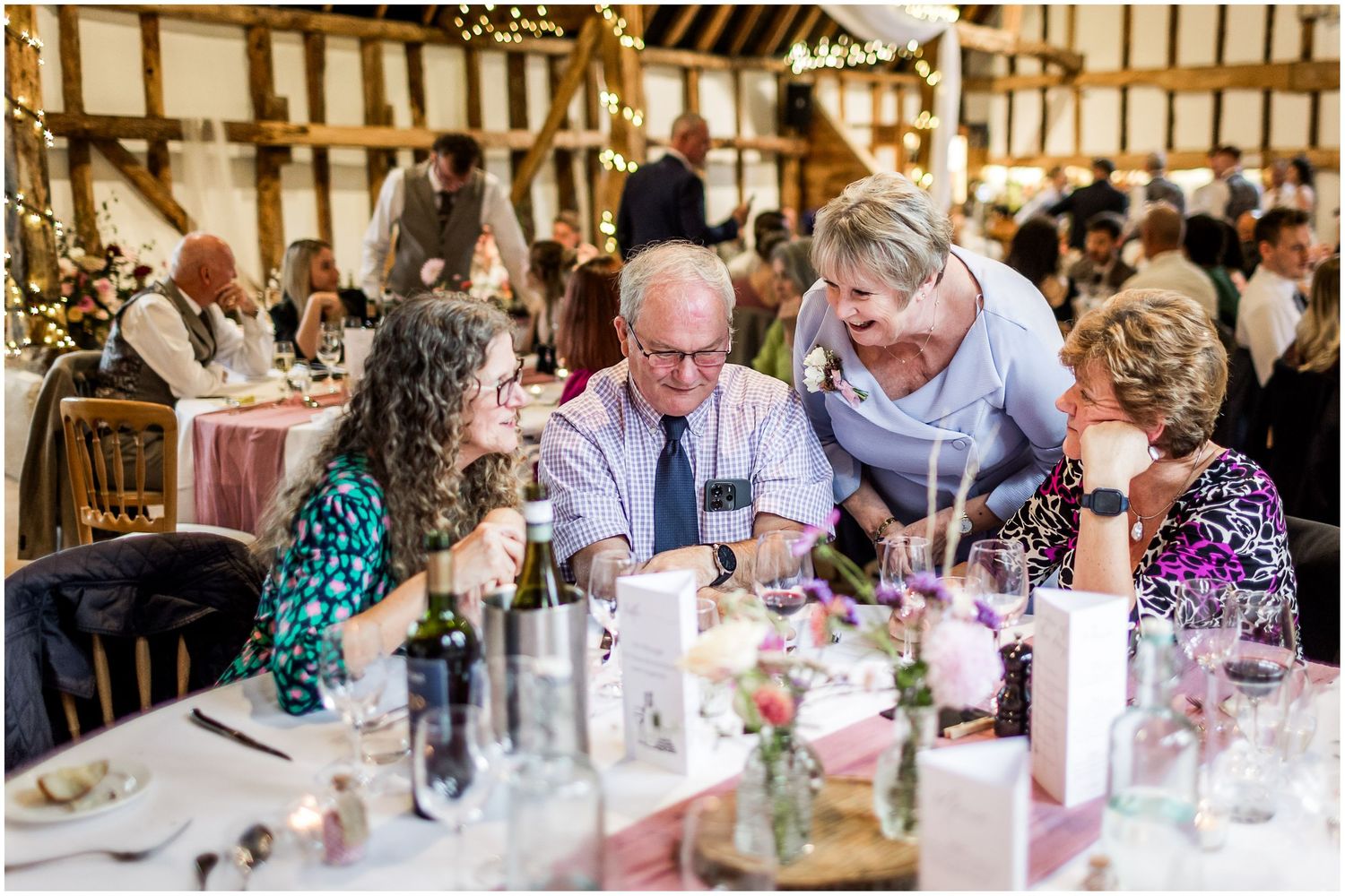 Photograph of wedding guests in the main dining room at Clock Barn during the wedding breakfast