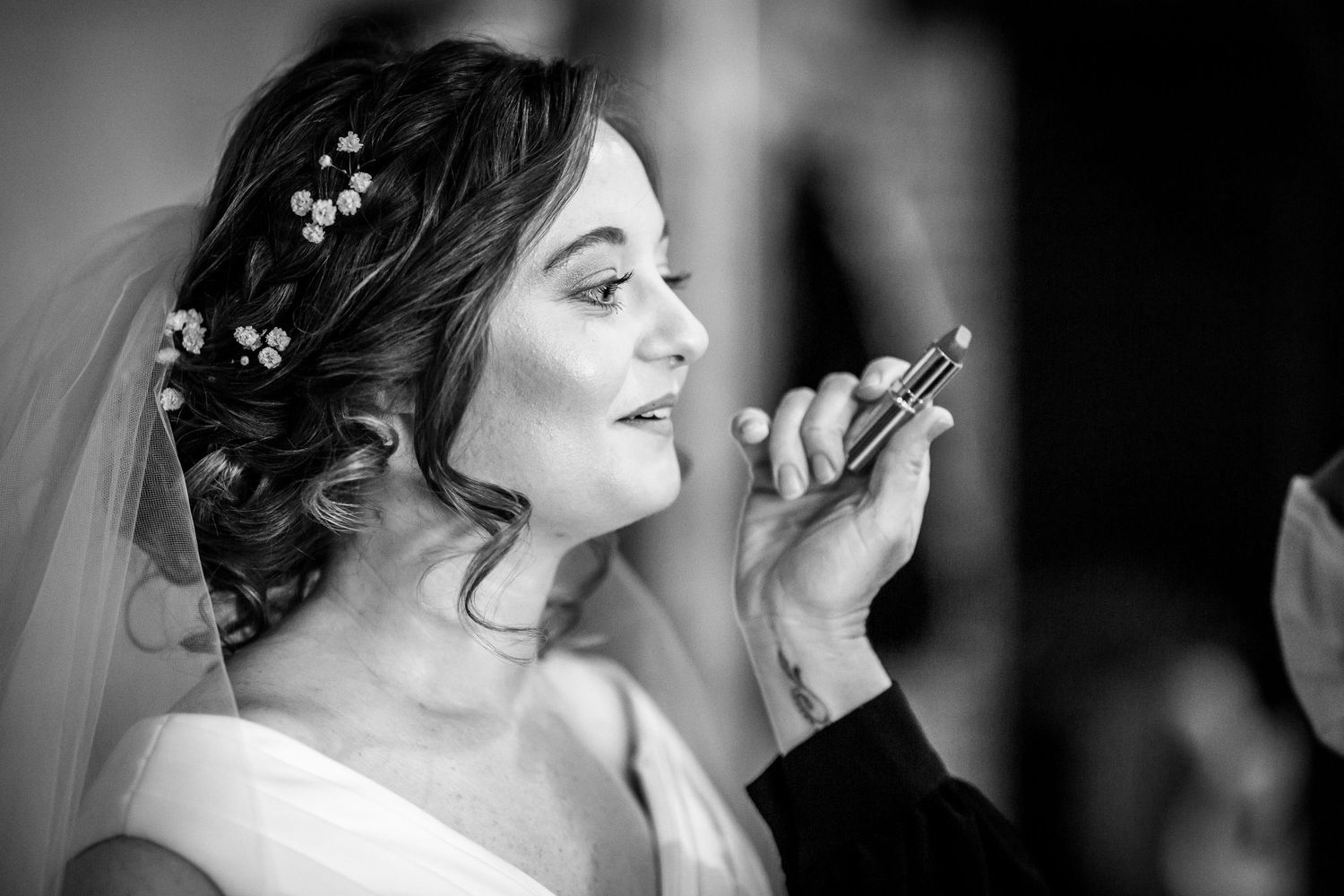 Black and white bride portrait during hair and make up in the bridal dressing room at Clock Barn wedding venue near Winchester
