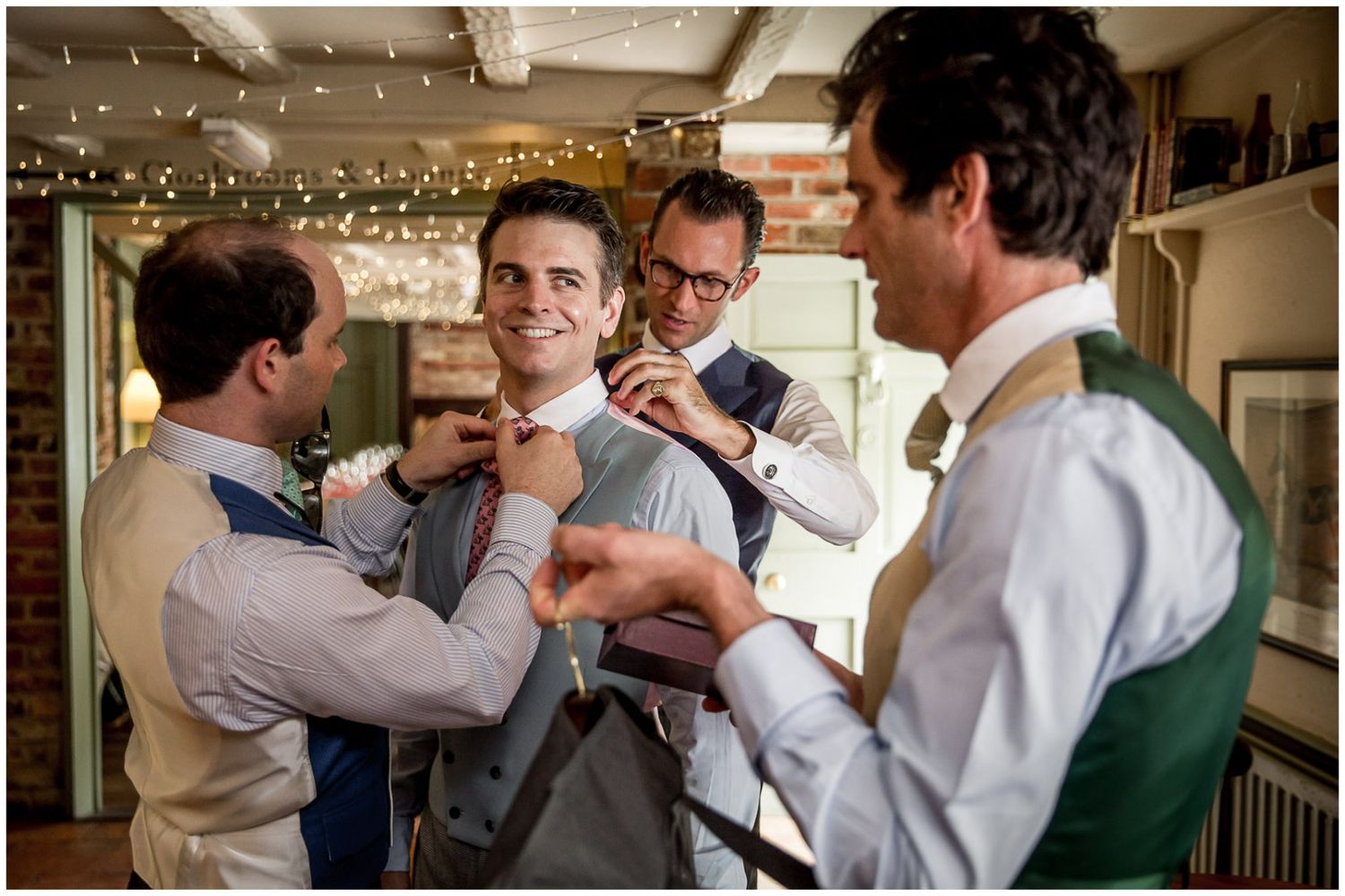 People in white shirts and formal attire gather closely together in what appears to be a social event or celebration.