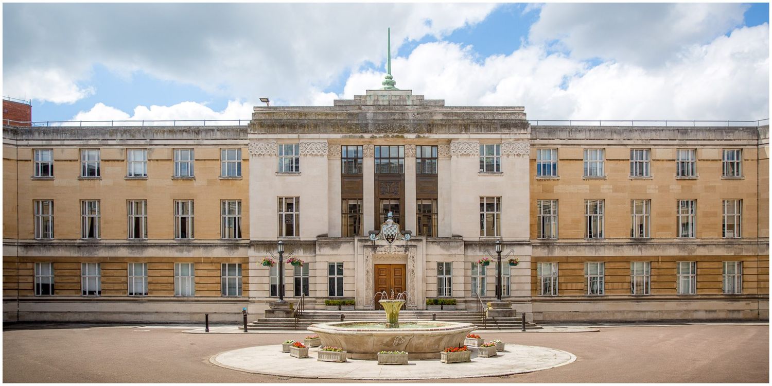 Panoramic view of a grand historic building with classical architecture under blue skies.