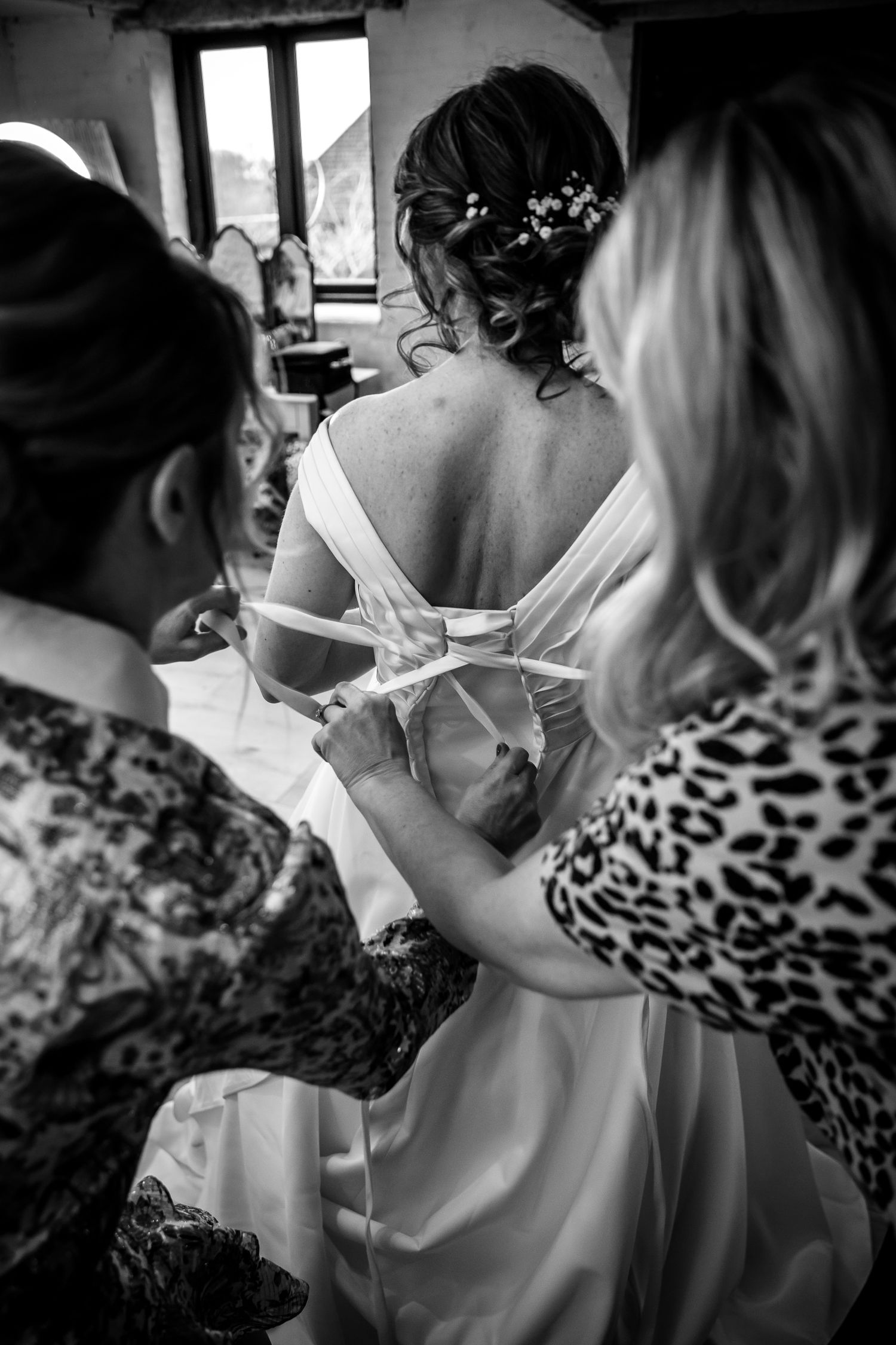 Black and white bridal preparation photograph in the Clock Barn dressing room