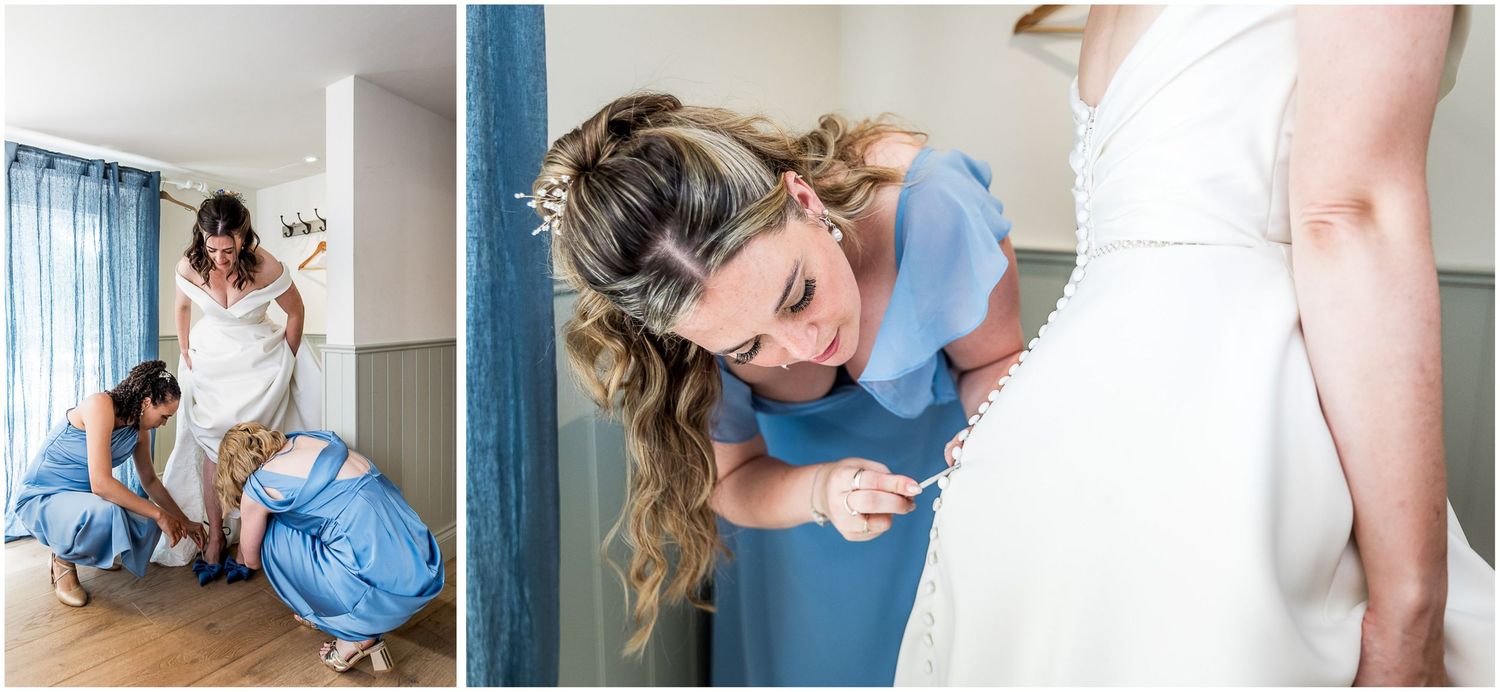 Bridesmaids in blue dresses helping bride get ready, adjusting wedding gown details before the ceremony.