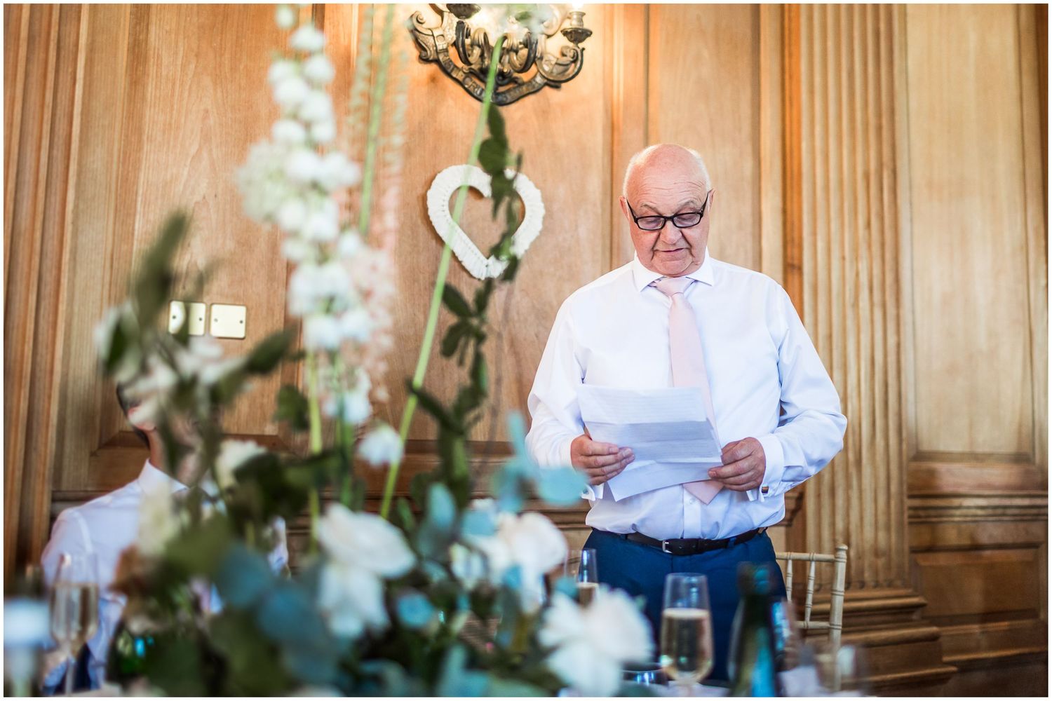 The father of the bride gives a wedding speech at the end of the meal in the dining hall of Walhampton School
