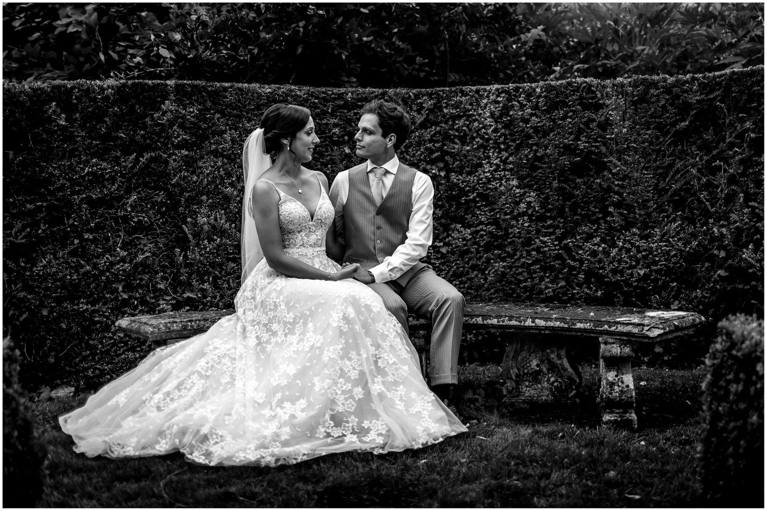 Artistic black and white wedding portraits showing romantic moments in a garden setting.