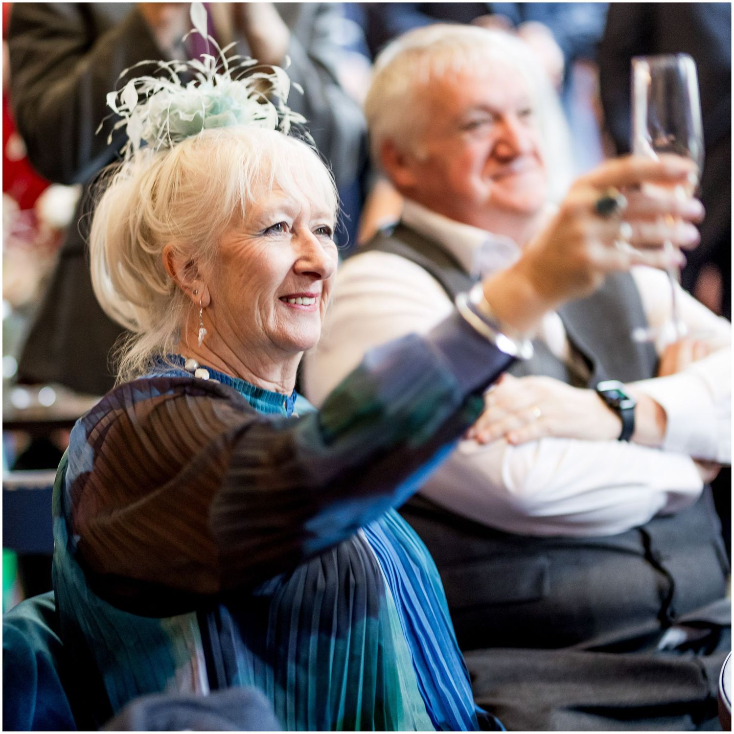 A wedding guest raises a toast to the bride and groom.