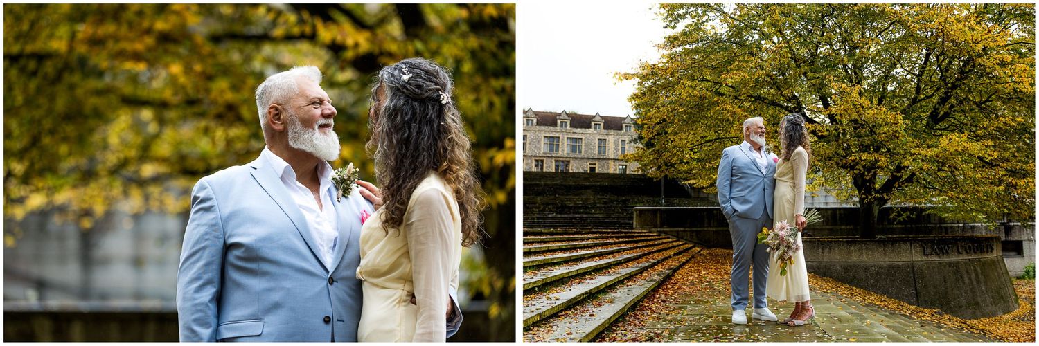 Bride and groom wedding photography on the steps of Winchester law courts with Autumn colour in the background.