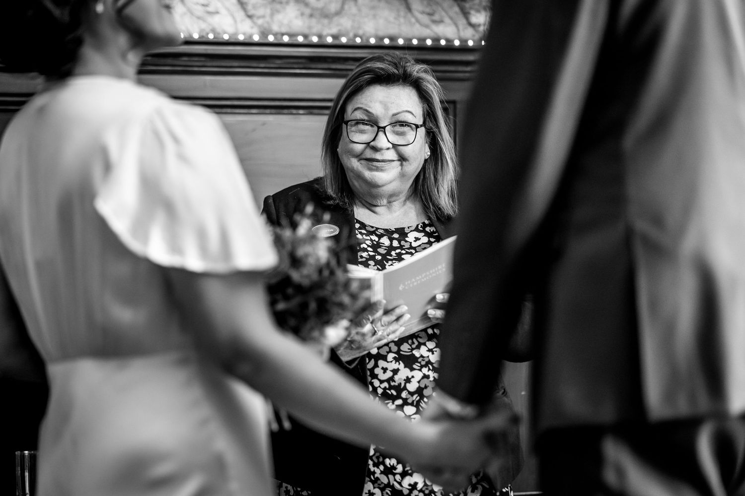 Black and white candid moments captured during wedding reception celebrations.