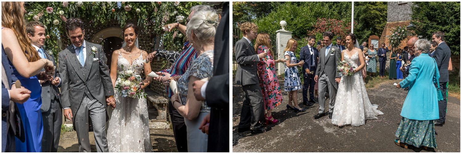 Wedding guests and celebration outside on a sunny garden path.