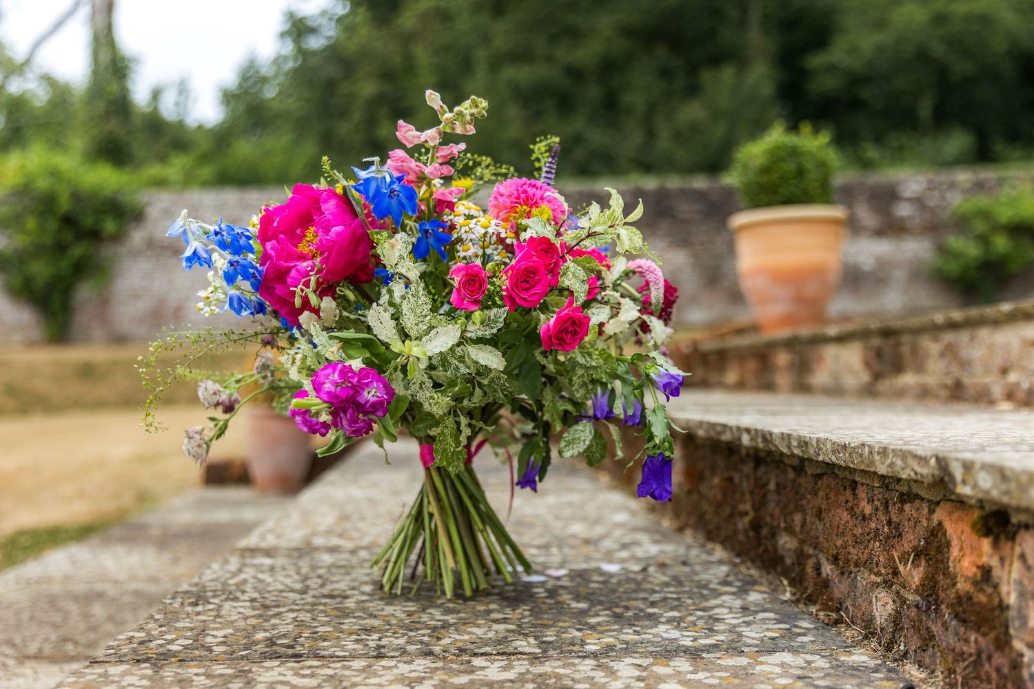 A bride's wedding bouquet photographed in the stone steps by the gazebo at the Holywell Estate