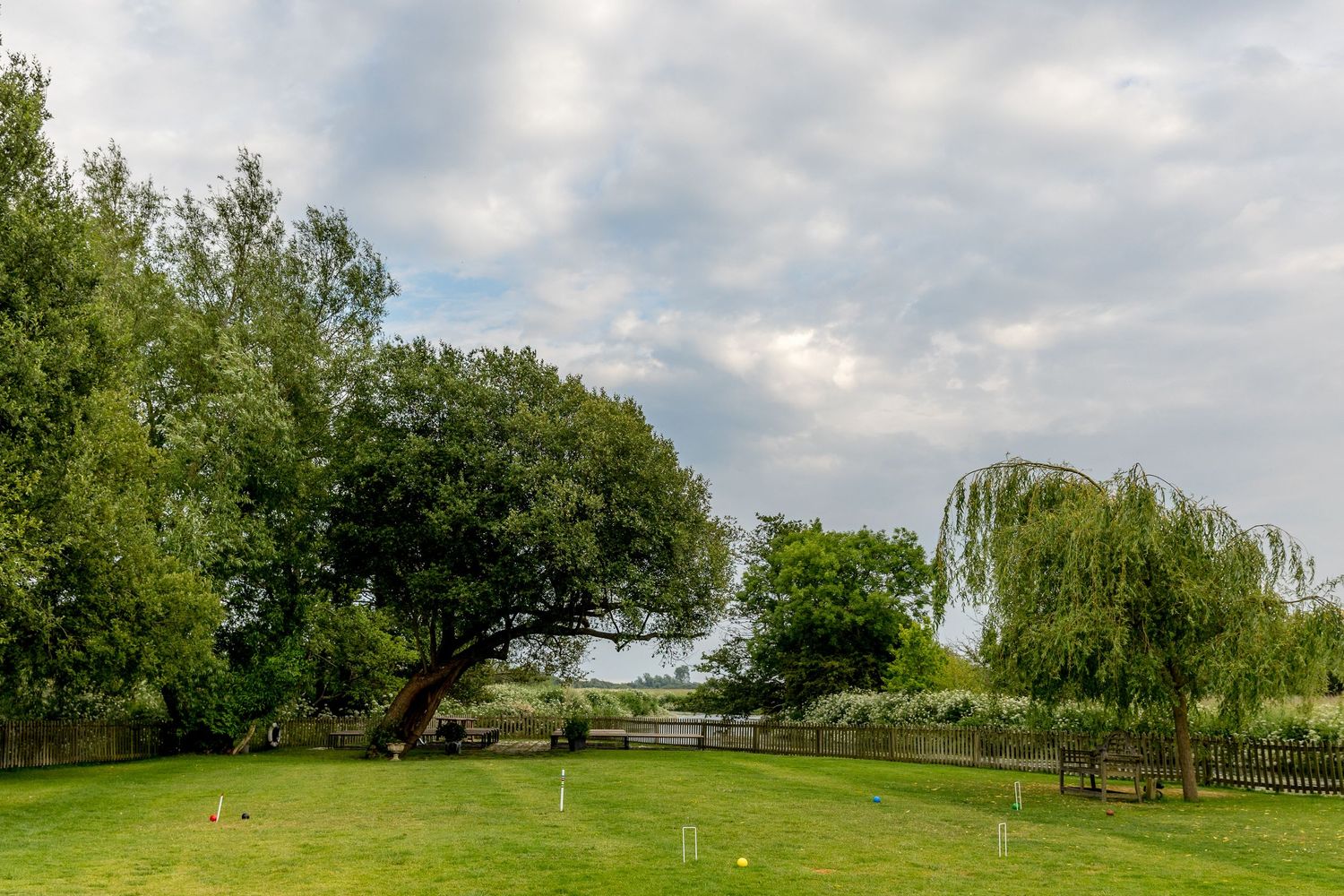 Panoramic view of a landscaped garden venue with rolling hills in the background.